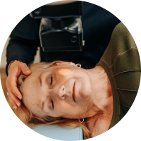 Closup shot of a patient laying on her side while receiving EBT treatment. A light from the Mobetron machine focuses on a small patch of skin.